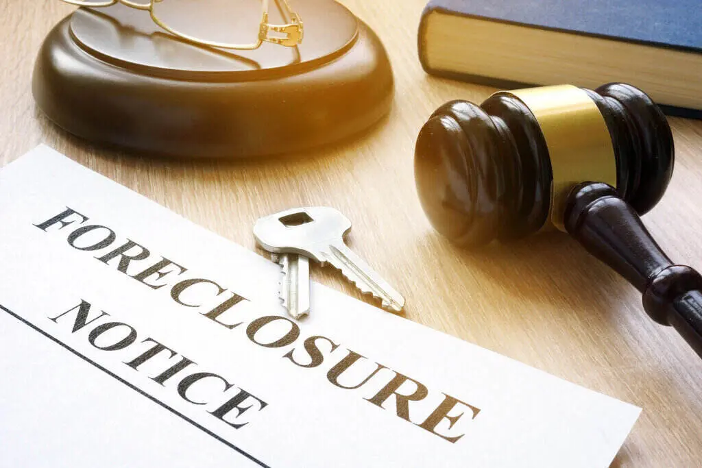 Foreclosure notice with house keys, gavel, and law book symbolizing the legal process and urgency homeowners in Dallas face when at risk of losing their property